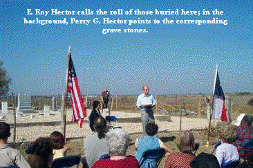 E. Roy Hector calls the roll of those buried here; in the background, Perry G Hector points to the corresponding grave stones.